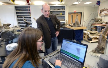 scientist with student preparing 3-D scans